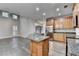 Bright kitchen featuring an island, stainless steel appliances, granite countertops, and wood cabinets at 5015 Riverthur Pl, Peachtree Corners, GA 30096