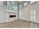 Bright living room with fireplace, hardwood floors and large windows at 5015 Riverthur Pl, Peachtree Corners, GA 30096