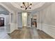 Spacious living area features hardwood floors, wainscoting, and an open layout to the kitchen at 5015 Riverthur Pl, Peachtree Corners, GA 30096