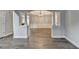 Open-concept living room featuring hardwood floors and architectural columns leading to other rooms at 5015 Riverthur Pl, Peachtree Corners, GA 30096