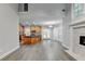Open concept living room and kitchen with hardwood floors and modern appliances at 5015 Riverthur Pl, Peachtree Corners, GA 30096