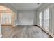Spacious living room featuring hardwood floors, white trim, and large windows at 5015 Riverthur Pl, Peachtree Corners, GA 30096