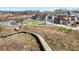 Community aerial view with a curved wooden walkway, amphitheater, and pond at 5575 Mirror Lake Dr, Cumming, GA 30028