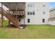 Back of home with deck, stairs, grass, and newly-laid mulch at 5575 Mirror Lake Dr, Cumming, GA 30028