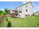Exterior shot of a home's backyard featuring a lawn, and covered deck at 5575 Mirror Lake Dr, Cumming, GA 30028