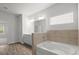 This bathroom features a soaking tub and a single sink at 5575 Mirror Lake Dr, Cumming, GA 30028