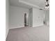 This bedroom features neutral walls, carpeted floors, a ceiling fan, and multiple windows at 5575 Mirror Lake Dr, Cumming, GA 30028