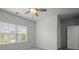 Bright bedroom with a ceiling fan, carpeted floors, and a window offering natural light at 5575 Mirror Lake Dr, Cumming, GA 30028