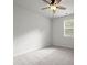 This bedroom features neutral walls, carpeted floors, a ceiling fan, and a window at 5575 Mirror Lake Dr, Cumming, GA 30028