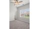 This bedroom features carpeted floors, a ceiling fan, and a window for natural light at 5575 Mirror Lake Dr, Cumming, GA 30028