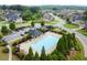 Aerial shot of community pool, lounge chairs, and landscaping, plus community parking at 5575 Mirror Lake Dr, Cumming, GA 30028