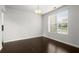 Bright dining room featuring a large window and hardwood flooring at 5575 Mirror Lake Dr, Cumming, GA 30028