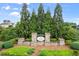 Landscaped entrance to Whisper Point community with stone signage and well-maintained greenery at 5575 Mirror Lake Dr, Cumming, GA 30028