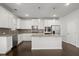 Gourmet kitchen boasts stainless steel appliances, granite countertops, and island at 5575 Mirror Lake Dr, Cumming, GA 30028