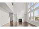 Spacious living room with soaring ceilings, fireplace, and plenty of natural light at 5575 Mirror Lake Dr, Cumming, GA 30028
