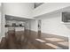 Open-concept living space with hardwood floors connecting to the kitchen at 5575 Mirror Lake Dr, Cumming, GA 30028