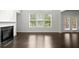 Bright living room featuring fireplace, access to the back yard and hardwood floors at 5575 Mirror Lake Dr, Cumming, GA 30028