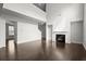 Open-concept living room featuring fireplace, hardwood floors, and neutral paint at 5575 Mirror Lake Dr, Cumming, GA 30028