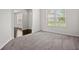 Carpeted living room filled with natural light at 5575 Mirror Lake Dr, Cumming, GA 30028