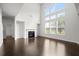 Bright living room with fireplace, hardwood flooring, and large windows at 5575 Mirror Lake Dr, Cumming, GA 30028
