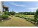 Expansive backyard featuring a manicured lawn, lush greenery, and a picturesque view of the meadow at 5915 Read Rd, Suwanee, GA 30024