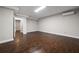 Spacious finished basement with dark wood floors, neutral walls, and access to additional rooms at 5915 Read Rd, Suwanee, GA 30024