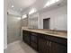 Bathroom featuring double vanity, marble countertops, and a glass enclosed shower at 5915 Read Rd, Suwanee, GA 30024