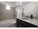 Bathroom featuring tiled shower and floors, granite vanity top and undermount sink at 5915 Read Rd, Suwanee, GA 30024