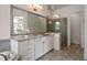 A spacious bathroom features a large mirror and an elegant glass shower enclosure at 5915 Read Rd, Suwanee, GA 30024