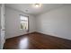 Bright bedroom featuring hardwood floors and a window letting in natural light at 5915 Read Rd, Suwanee, GA 30024