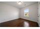 Bright bedroom with hardwood floors and a large window offering outdoor views at 5915 Read Rd, Suwanee, GA 30024