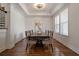 Formal dining room with hardwood floors, tray ceiling and sophisticated chandelier lighting at 5915 Read Rd, Suwanee, GA 30024