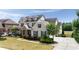 The front exterior features a stone-accented facade, dormer windows, and a neatly landscaped yard at 5915 Read Rd, Suwanee, GA 30024