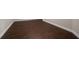 Close up of dark laminated flooring with bright white baseboards at 5915 Read Rd, Suwanee, GA 30024