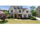 Beautiful two-story home with manicured lawn, stone accents, and charming curb appeal at 5915 Read Rd, Suwanee, GA 30024