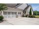 A spacious three-car garage enhances the home's functionality, complete with carriage-style doors at 5915 Read Rd, Suwanee, GA 30024