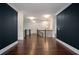 Open hallway upstairs with wood floors, wrought iron railing, and ample natural light at 5915 Read Rd, Suwanee, GA 30024