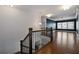 Open hallway upstairs with wood floors, wrought iron railing, and ample natural light at 5915 Read Rd, Suwanee, GA 30024