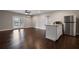 Open concept kitchen and living area with stainless steel appliances and hardwood floors at 5915 Read Rd, Suwanee, GA 30024