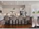 Beautiful kitchen includes island with bar stools, stainless appliances, and custom cabinetry at 5915 Read Rd, Suwanee, GA 30024