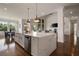 Gourmet kitchen with stainless appliances, large island with a sink, and views into the open living space at 5915 Read Rd, Suwanee, GA 30024