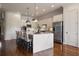 Charming kitchen featuring an island with bar stool seating, stainless appliances, and custom cabinetry at 5915 Read Rd, Suwanee, GA 30024