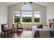 Bright main bedroom features hardwood floors, tall windows with backyard views, and vaulted ceiling at 5915 Read Rd, Suwanee, GA 30024