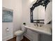 Stylish powder room features a pedestal sink, and an ornate mirror at 5915 Read Rd, Suwanee, GA 30024