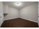 Cozy room with wood floors, neutral walls, and minimalist decor for versatile use at 5915 Read Rd, Suwanee, GA 30024