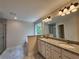 Bathroom with double vanity, granite countertops, large mirror, and tiled shower at 68 Jeffrey Ln, Dallas, GA 30157