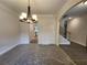 This dining room features an elegant chandelier, complemented by access to a staircase and other living spaces at 68 Jeffrey Ln, Dallas, GA 30157