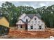 New construction home featuring durable house wrap and black roof in a serene wooded setting at 68 Jeffrey Ln, Dallas, GA 30157