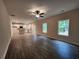 Open-concept living area with kitchen, featuring modern flooring, bright windows, and a ceiling fan at 68 Jeffrey Ln, Dallas, GA 30157