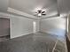 Expansive main bedroom showcasing a tray ceiling, neutral walls and a ceiling fan at 68 Jeffrey Ln, Dallas, GA 30157
